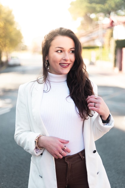 Young caucasian woman portrait standing in the middle of the street