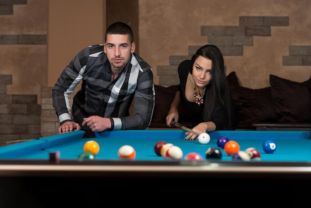 Young Caucasian Woman Receiving Advice On Shooting Pool Ball While Playing Billiards