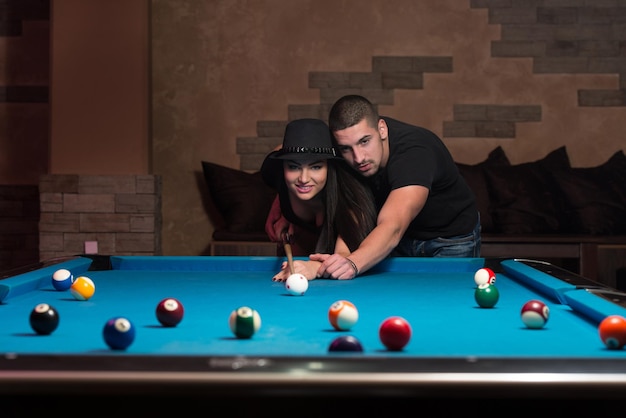 Young Caucasian Woman Receiving Advice On Shooting Pool Ball While Playing Billiards