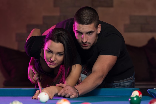 Young Caucasian Woman Receiving Advice On Shooting Pool Ball While Playing Billiards