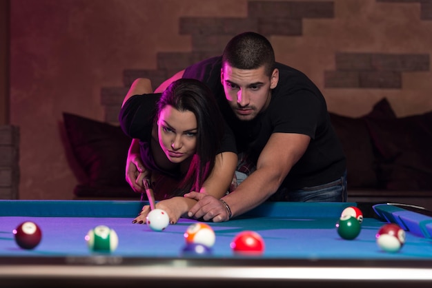 Young Caucasian Woman Receiving Advice On Shooting Pool Ball While Playing Billiards