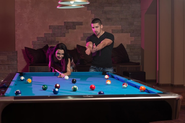 Young Caucasian Woman Receiving Advice On Shooting Pool Ball While Playing Billiards