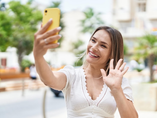 Young caucasian woman smiling confident having video call at street