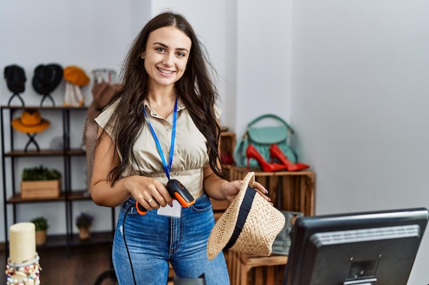 Young caucasian woman smiling confident working at clothing store