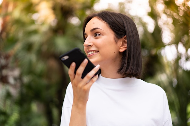 Young caucasian woman using a phone at outdoors