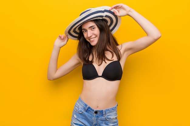 Young caucasian woman wearing a bikini and pamela