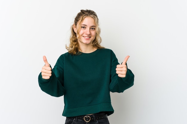 Young caucasian woman on white smiling and raising thumb up