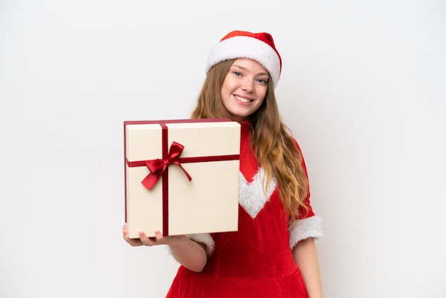 Young caucasian woman with Christmas dress holding gift isolated on white background with happy expression