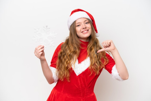 Young caucasian woman with Christmas dress holding snowflake isolated on white background proud and selfsatisfied