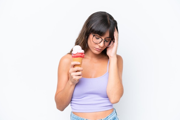 Young caucasian woman with a cornet ice cream over isolated white background with headache