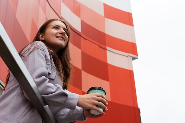 Young caucasian woman with glass of coffee