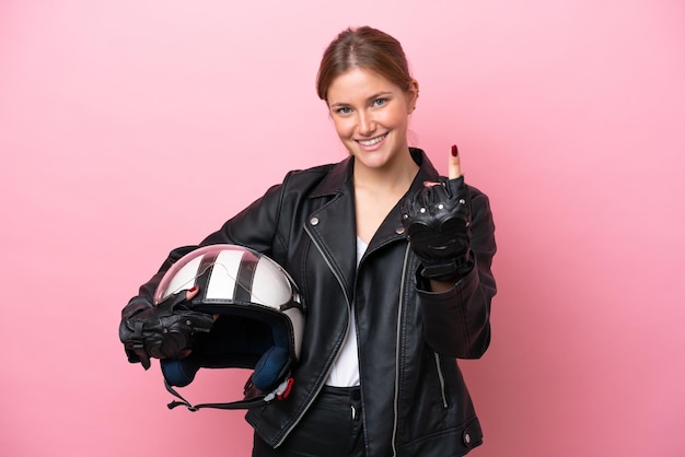 Young caucasian woman with a motorcycle helmet isolated on pink background doing coming gesture