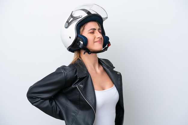 Young caucasian woman with a motorcycle helmet isolated on white background suffering from backache for having made an effort