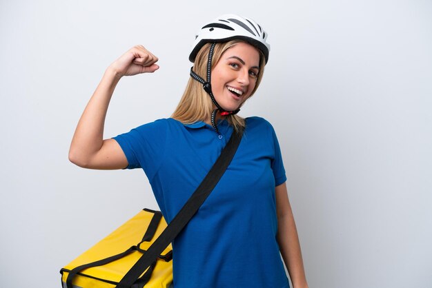 Young caucasian woman with thermal backpack isolated on white background doing strong gesture