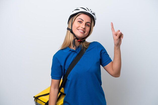 Young caucasian woman with thermal backpack isolated on white background showing and lifting a finger in sign of the best