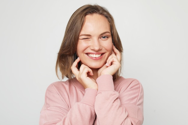 Young and cheerful blonde woman smiling and laughing looking at the camera