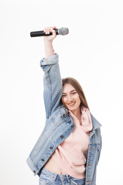 Young cheerful caucasian woman holding microphone isolated on white background