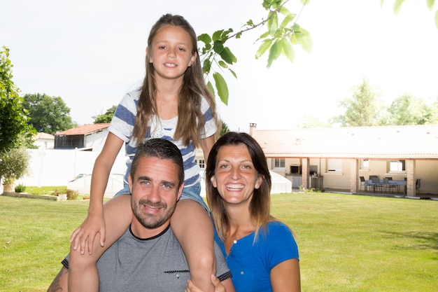 Young cheerful family  in front of new house home