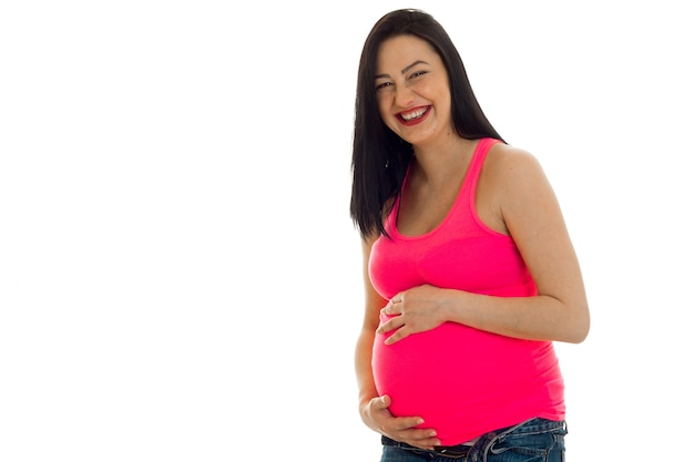 Young cheerful pregnant mother laughing isolated on white background in studio