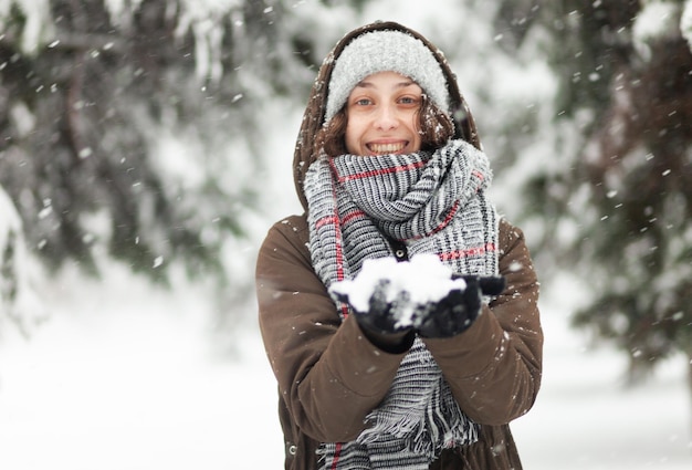 Young cheerful woman glad to snow