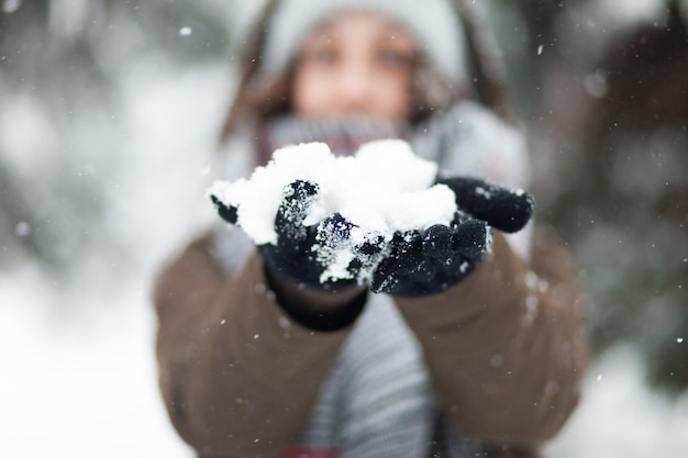 Young cheerful woman glad to snow