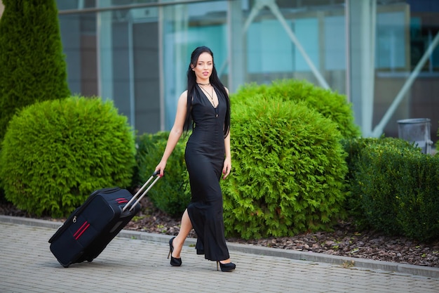 Young Cheerful Woman With a Suitcase