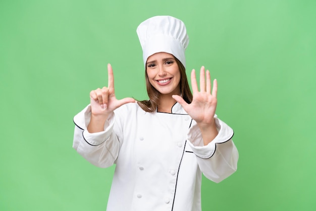 Young chef caucasian woman over isolated background counting seven with fingers