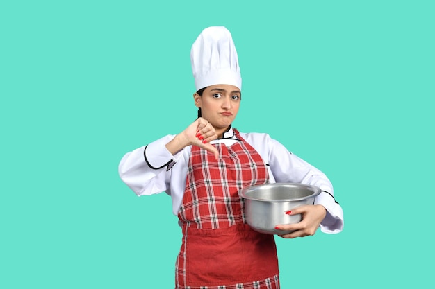 young chef girl front pose holding pan indian pakistani model