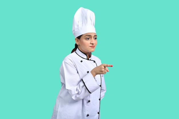 young chef girl white outfit over green background indian pakistani model