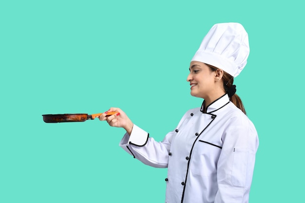 young chef girl white outfit holding pan indian pakistani model