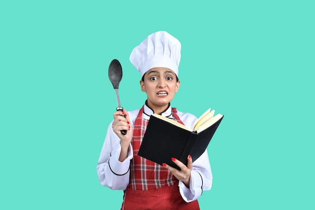 young chef girl white outfit reading food recipe indian pakistani model