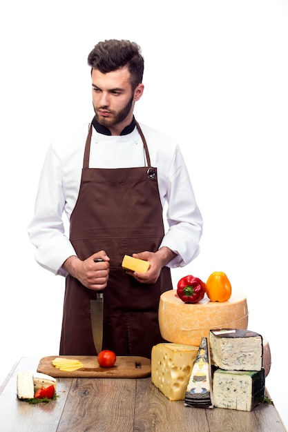 Young chef with cheeses isolated on white wall, Cheese advertisement