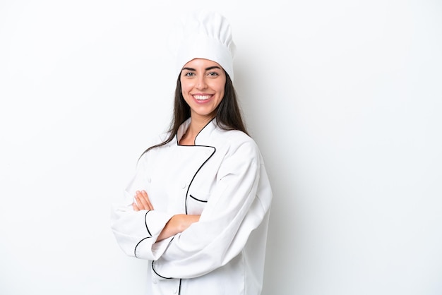 Young chef woman over white background with arms crossed and looking forward