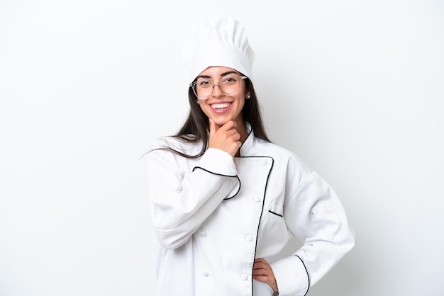 Young chef woman over white background with glasses and smiling