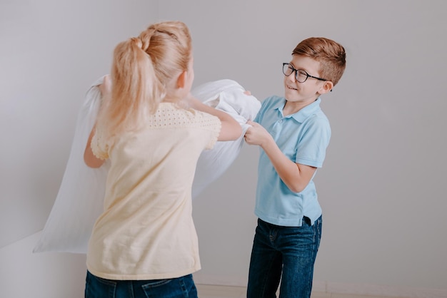 Young children playing with the pillows Happy childhood concept