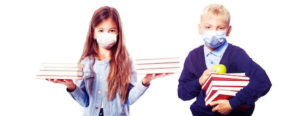 Young children with protection masks against corona virus at school.