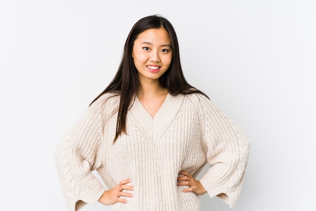 Young chinese woman isolated confident keeping hands on hips.