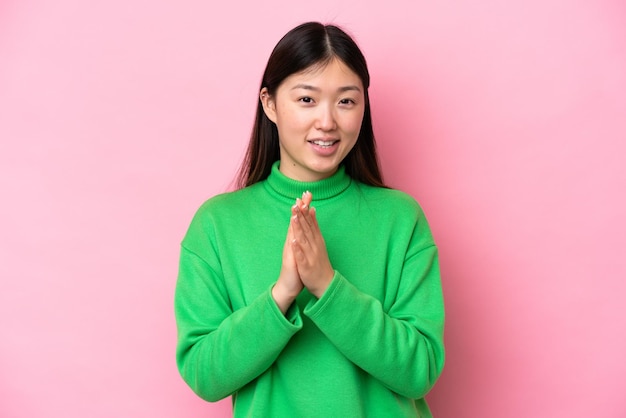 Young Chinese woman isolated on pink background applauding after presentation in a conference