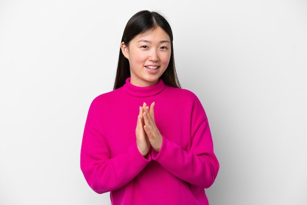 Young Chinese woman isolated on white background applauding after presentation in a conference