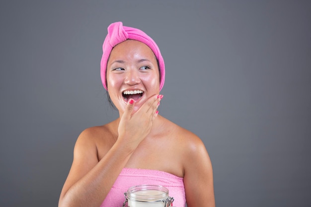 Young chinese woman taking care of her facial skin