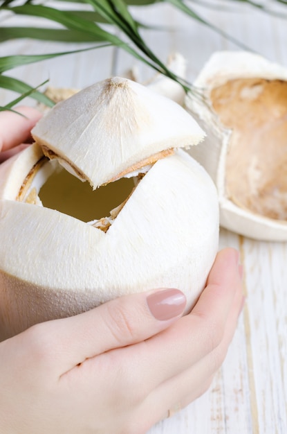 Photo young coconut on white wooden .