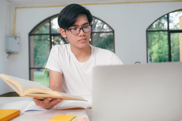 Young collage student using computer and mobile device studying online Education and online learning