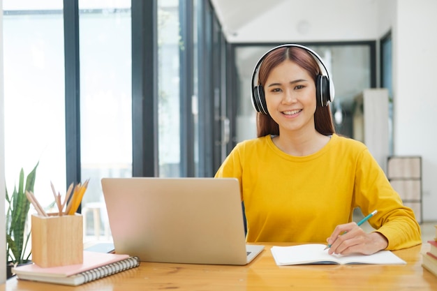 Young collage student using computer and mobile device studying online