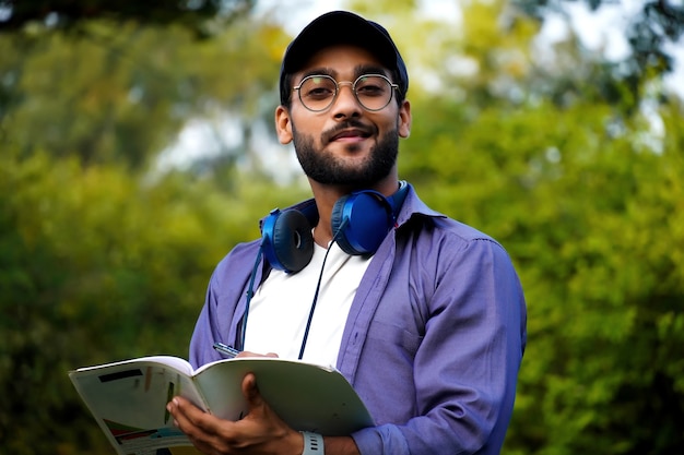 Young collage student with books and pen