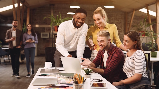 Young colleagues discussing ideas in coworking office