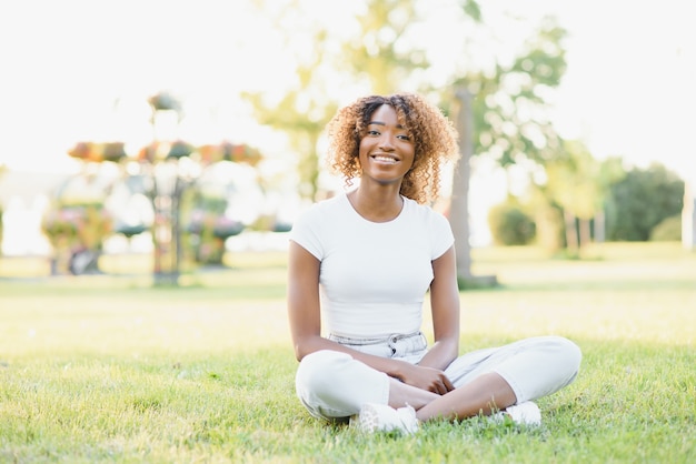 Young college student sitting on the lawn