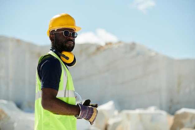 Young confident african american male engineer in workwear looking at you