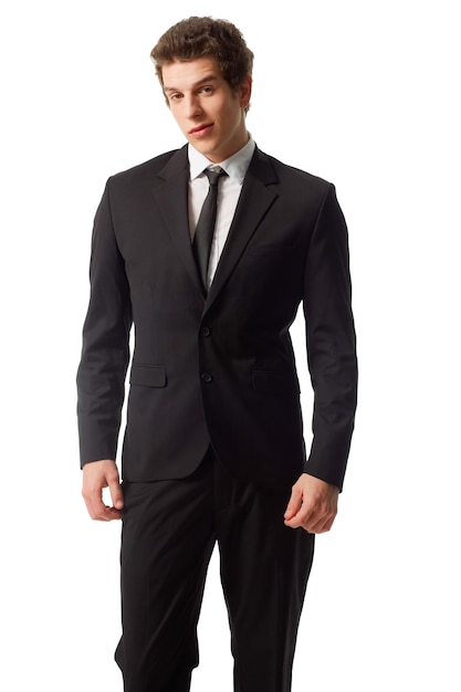 Young and confident A confident young man standing in a suit against a white background