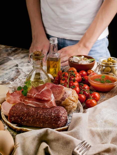 Young cook and ingredients for homemade traditional pizza