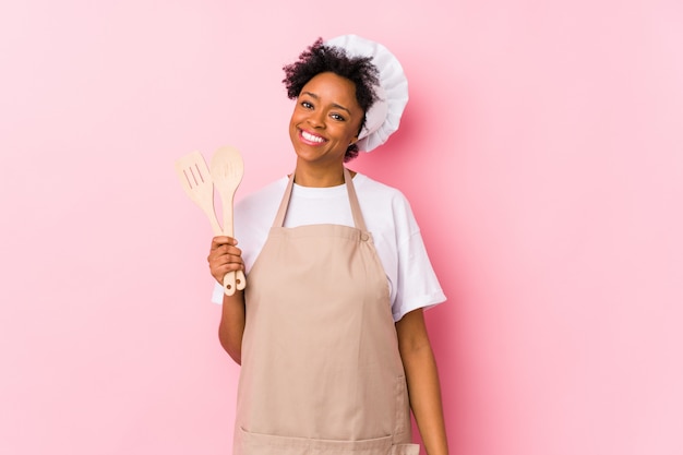 Young cook woman happy, smiling and cheerful